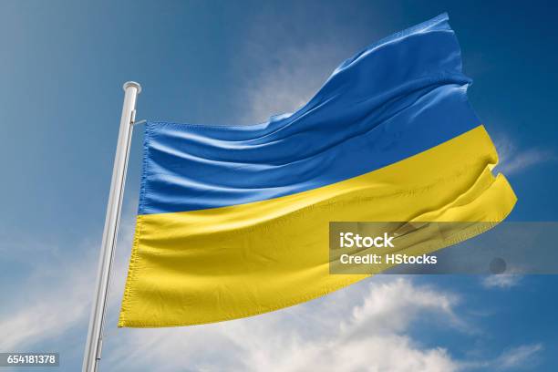Ukrainian Flag Is Waving Against Blue Sky Stock Photo - Download Image Now - Ukraine, Ukrainian Flag, Flag