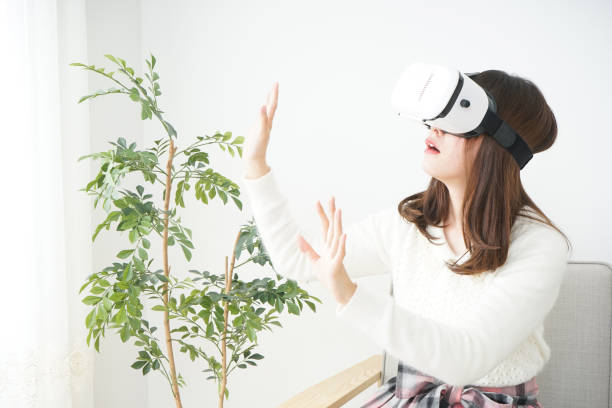 istock Young attractive Japanese woman using VR-headset glasses 654182008