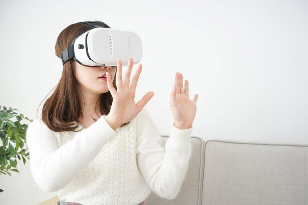 istock Young attractive Japanese woman using VR-headset glasses 654182050