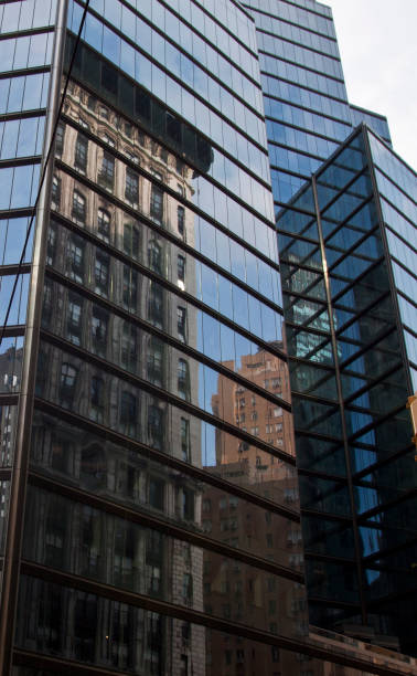 istock Reflection of old New York building in glass skyscraper 654183182