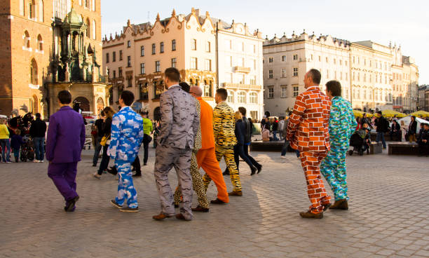 Stag party in brightly coloured clothing, Krakow. The Main Square or Rynek Główny in Krakow, Poland has been listed as one of the best squares in Europe as well as one of the best of the beat destinations in the world. Virtually every weekend, stag parties descend on the square to sample its many pubs and restaurants. Many of these parties compete with each other with brightly coloured or themed clothing. stag night stock pictures, royalty-free photos & images