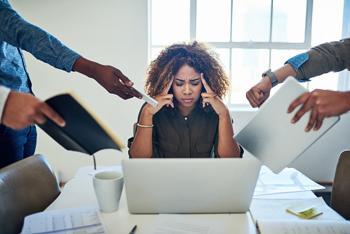 Shot of a stressed out young woman working in a demanding career