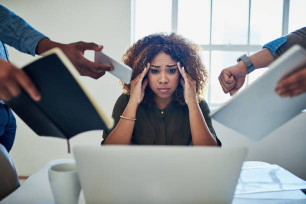 Can I get a moment to breathe? Shot of a stressed out young woman working in a demanding career excess stock pictures, royalty-free photos & images