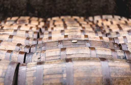 Whisky barrels full of whiskey in Scottish traditional distillery