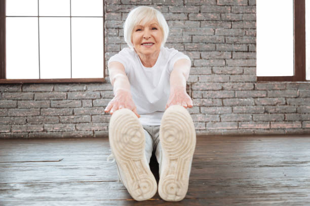 istock Charming female holding hands on her feet 654196762