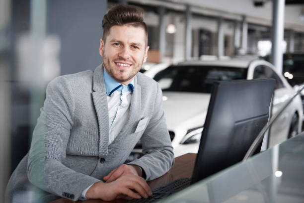istock Portrait of salesman leaning at computer desk 654202952