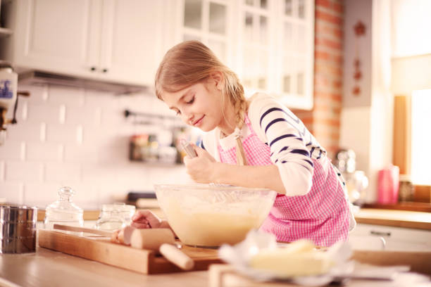 istock Little girl learning how to make proper dough 654203508