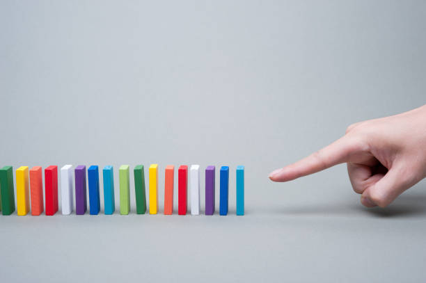 istock Colorful dominoes and human hands 654203886