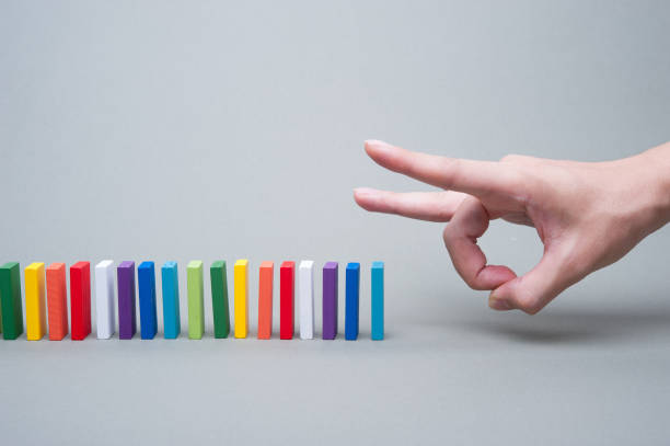 istock Colorful dominoes and human hands 654203898