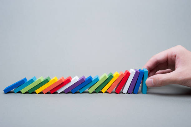 istock Colorful dominoes and human hands 654203926