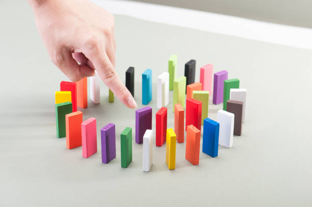istock Colorful dominoes and human hands 654204004