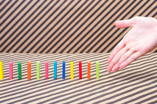 istock Colorful dominoes and human hands 654204044