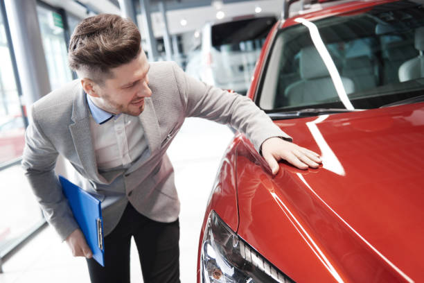 istock Car salesman examining vehicle before selling 654206298