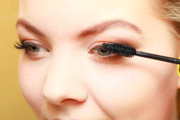 istock Close up woman getting make up, mascara 654206820