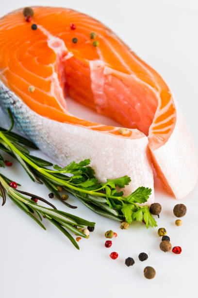 istock Raw salmon steak with rosemary isolated on white 654210166