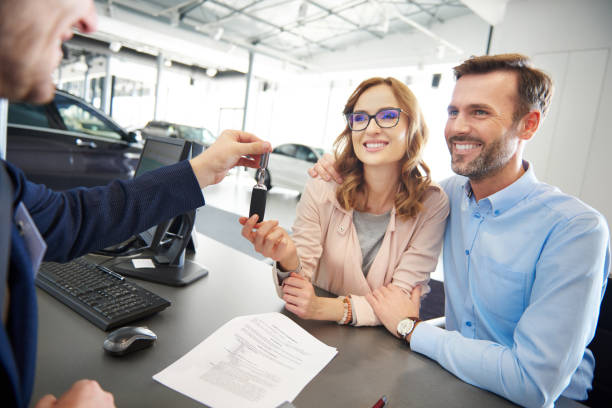 istock Excited couple receiving car keys 654216582