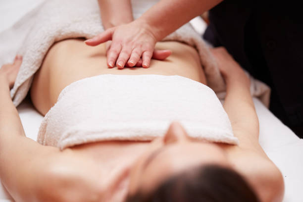 istock Beautiful girl having stomach massage 654223762