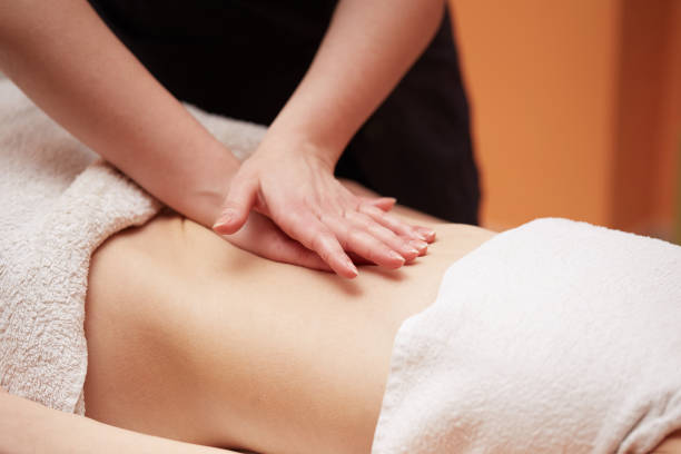 istock Beautiful girl having stomach massage 654224352