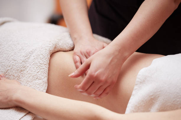 istock Beautiful girl having stomach massage 654224476