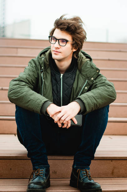 istock Hipster sitting on the stairs 654225302