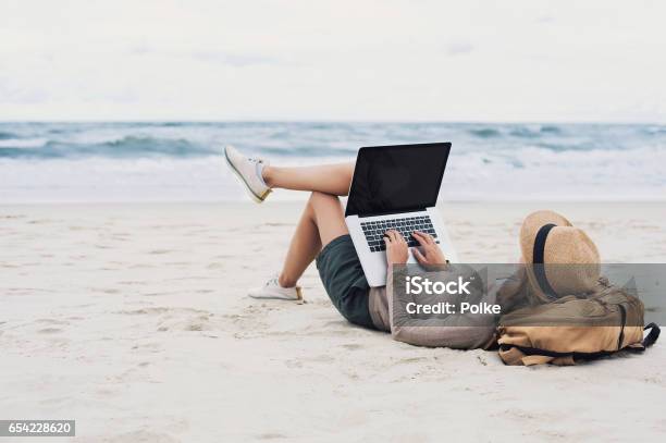 Young Woman Using Laptop On A Beach Stock Photo - Download Image Now - Laptop, Beach, Blogging