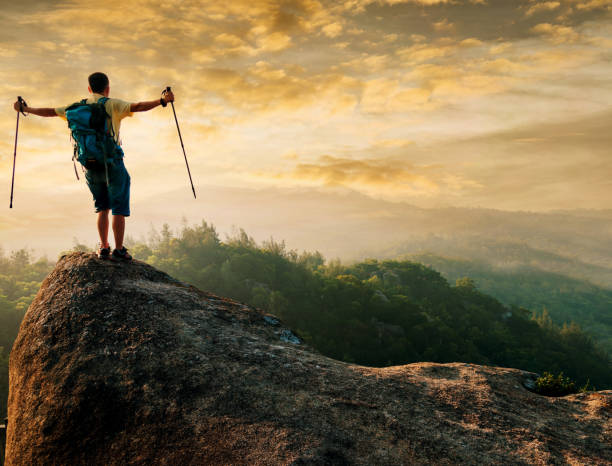 istock Man success standing at mountain peak 654231040