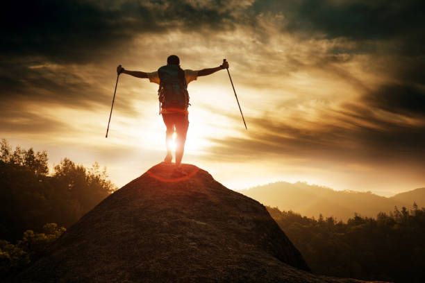 istock Man success standing at mountain peak 654231224