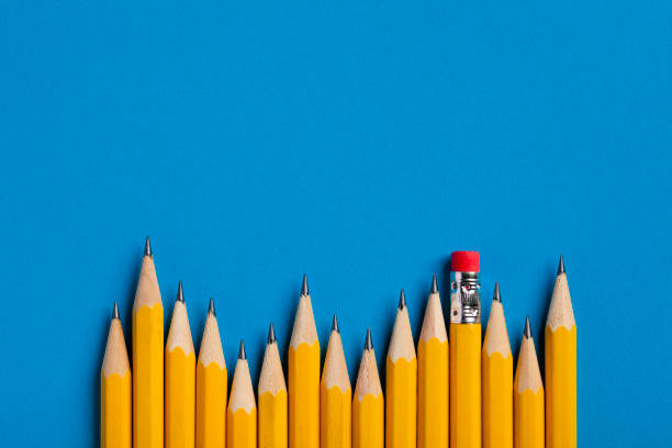 istock Yellow Pencils on blue paper 654238900