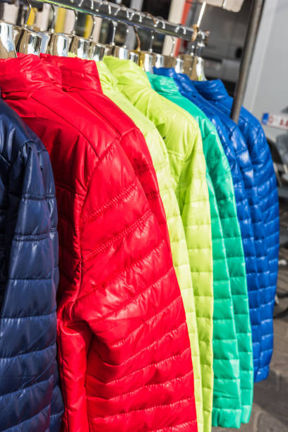 istock Winter clothes hanging at a store 654239084