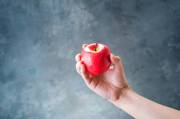 istock Man with a Red Apple in hand 654239422