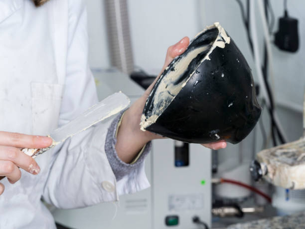 istock Dental technician is working with a dental flask of a complete upper on cast 654239680