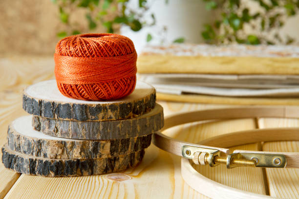 istock Balls of threads on wooden table 654239768