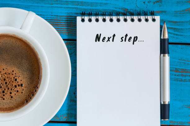 istock Next Steps inscription written in notepad near morning coffee cup. Business, technology, internet concept. Stock Image 654244612