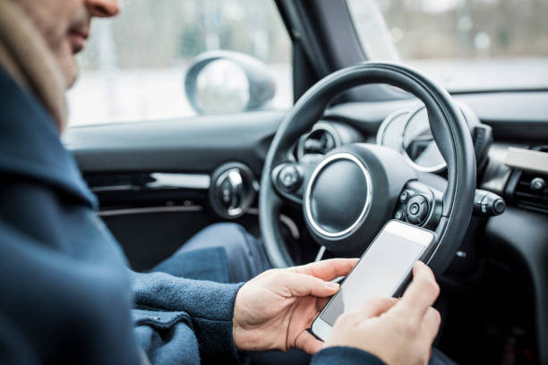istock Businessman using mobile phone in car 654244912