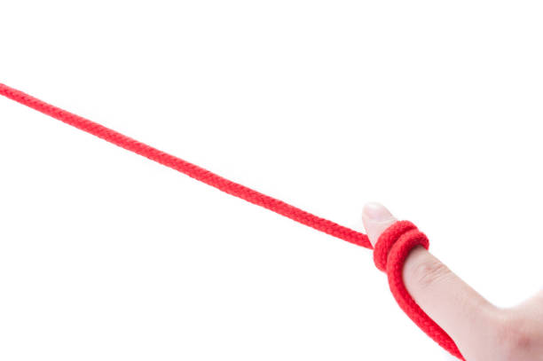 istock Fingers of humans with red thong 654252968