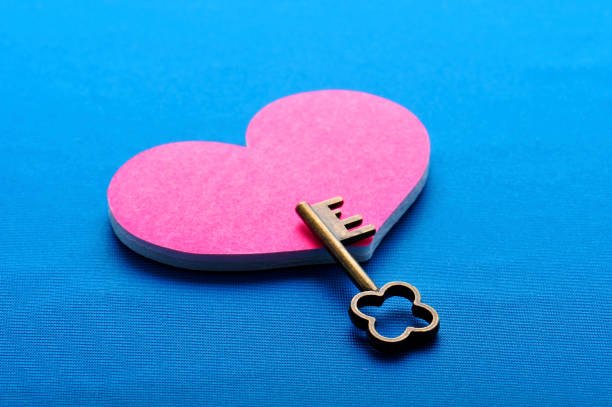 istock Pink heart and key with blue background 654253128