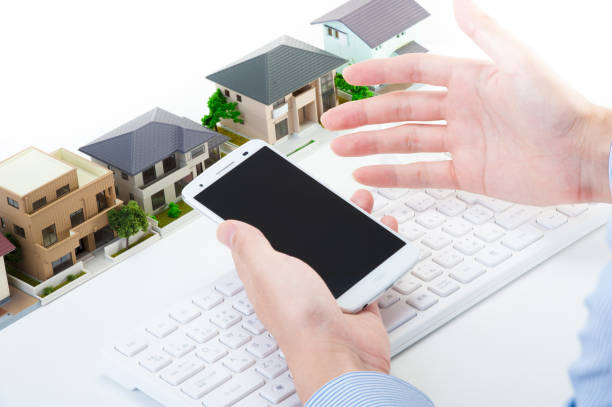 istock Hand with smart phones and miniature House 654259544
