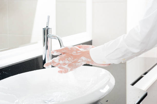 istock Women wash their hands at the sink 654266620