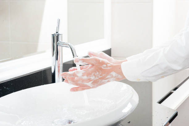 istock Women wash their hands at the sink 654266638