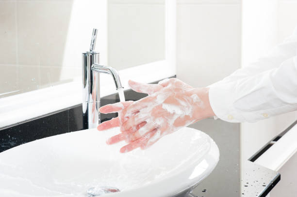 istock Women wash their hands at the sink 654266648