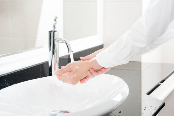 istock Women wash their hands at the sink 654266676
