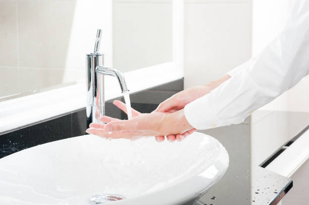 istock Women wash their hands at the sink 654266780