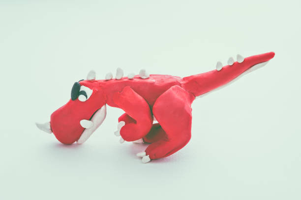 istock Red dinosaur clay model. Play dough animal. Vintage tone effect. 654270500