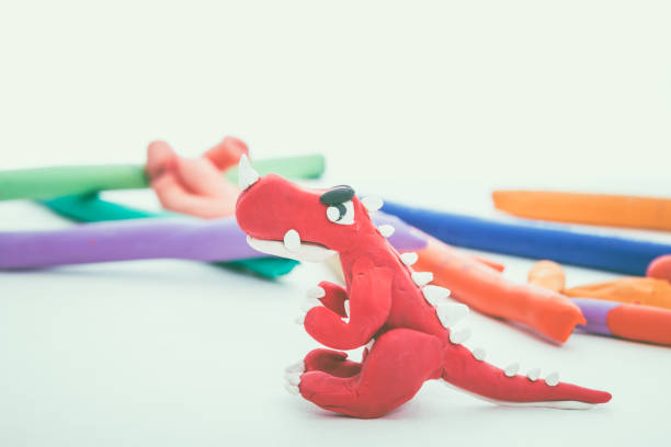 istock Red dinosaur clay model. Play dough animal. Vintage tone effect. 654270598