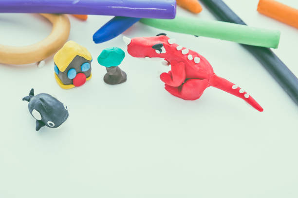 istock Red dinosaur clay model. Play dough animal. Vintage tone effect. 654270688