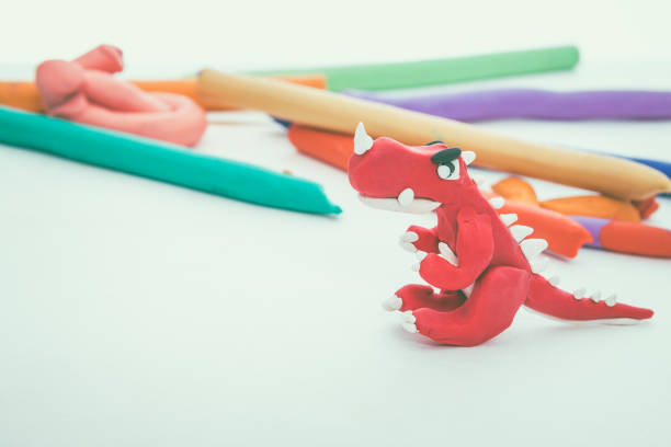 istock Red dinosaur clay model. Play dough animal. Vintage tone effect. 654270798