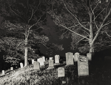A 19th century rural cemetery at night.  Long exposure with light painting.