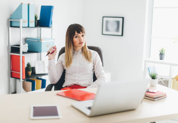 istock Busineswoman smiling broadly while working in her office 654283528