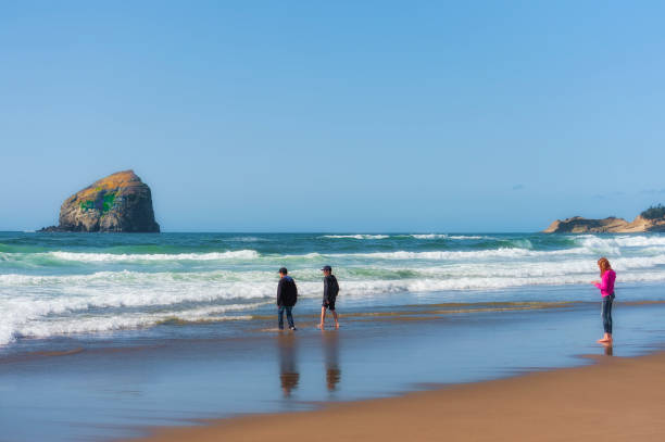 Kids walk along beach on Oregon Coast