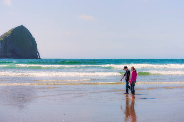 istock Siblings explore the surf at Pacific City on Oregon Coast 654287524